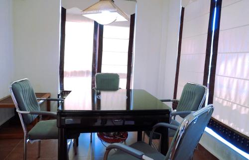 a dining room with a table and chairs at Avatar Valley Villas in Zhangjiajie