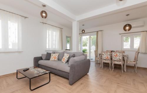 a living room with a couch and a table at Holiday Home VIKK in Makarska by Villas Guide in Drvenik