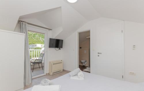 a white room with a view of a balcony at Holiday Home VIKK in Makarska by Villas Guide in Drvenik