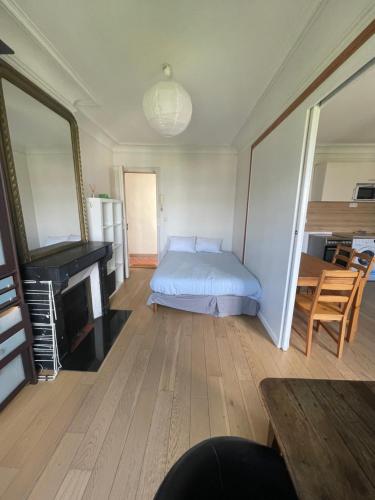 a bedroom with a bed and a piano in a room at Odéon in Paris