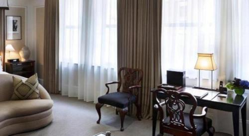 a hotel room with a desk with a computer and a chair at Fifteen Beacon Hotel in Boston
