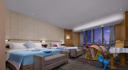 a hotel room with two beds and a tent at Changsha Huatian Hotel in Changsha