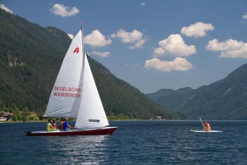 a group of people on a sail boat on a lake at Pension Bergblick - Nebenhaus C in Neusach