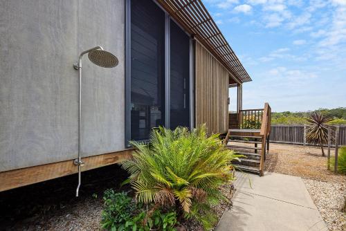 a house with a shower on the side of it at Reflections Evans Head - Holiday Park in Evans Head
