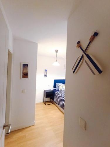 a room with a bedroom with a bed and two baseball bats at El Llambrion in Posada de Llanes