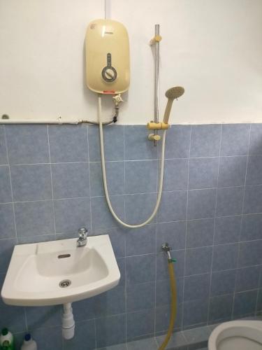a bathroom with a shower and a sink at Travellers Space 2 in Kuantan