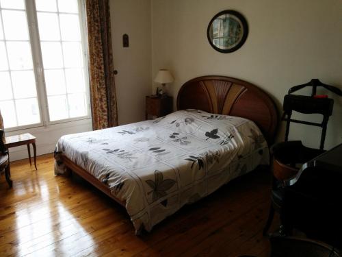 a bedroom with a bed with a white comforter at Le California in Biarritz