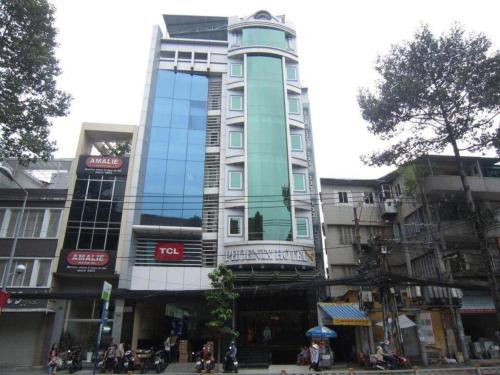 a tall building in the middle of a city at Phoenix Hotel Saigon in Ho Chi Minh City