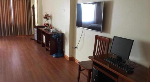 a living room with a desk with a computer on it at Viet Village Hotel in Hanoi