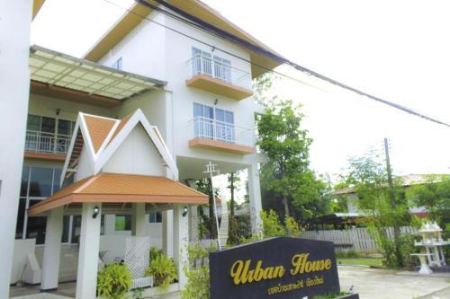 a white building with a sign in front of it at Urban House 195 in Chiang Mai