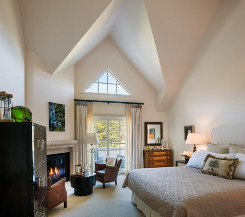 a bedroom with a bed and a fireplace at Seal Cove Inn in Half Moon Bay
