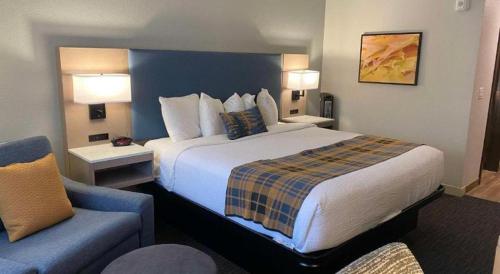 a hotel room with a large bed and a couch at Best Western Lake Lucille Inn in Wasilla
