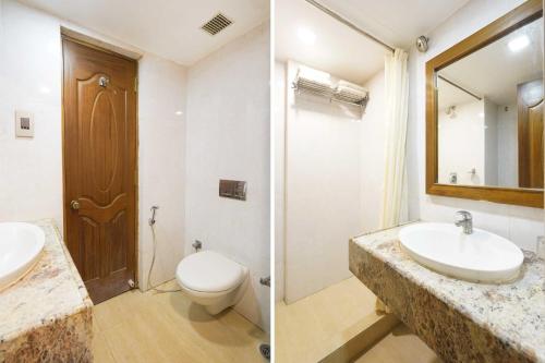 a bathroom with a sink and a toilet and a mirror at Palette Alandur Near Chennai Airport in Chennai