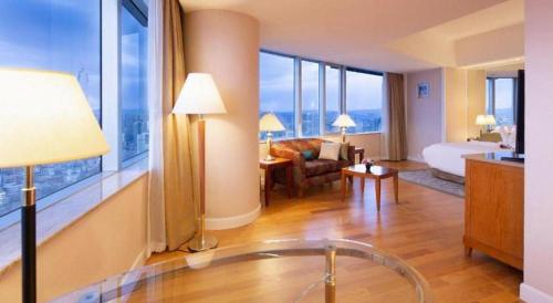 a hotel room with a bed and a living room at Kai Wah Plaza International Hotel in Kunming