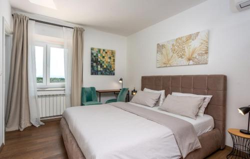 a bedroom with a large bed and a table at Villa Stanzia Natura Crikvenica by Villas Guide in Bakarac