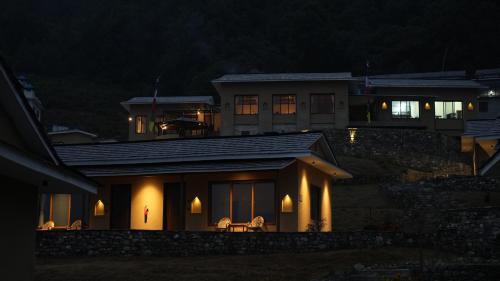 a house lit up at night with lights at Mountain Lodges of Nepal - Dhampus in Kāskī