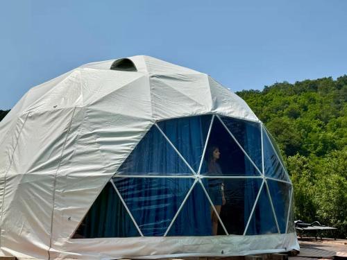 a man standing inside of a dome tent at Secluded Dome Retreat near Elena & Bikes 