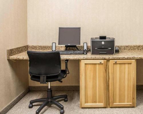 an office with a desk with a computer and a chair at Rodeway Inn & Suites Salina South in Salina