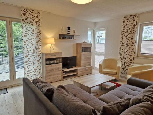 a living room with a couch and a tv at Villa Monika Steuerbord 5 in Sassnitz