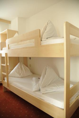 a couple of bunk beds in a room at Hotel Alpina in Kleinarl