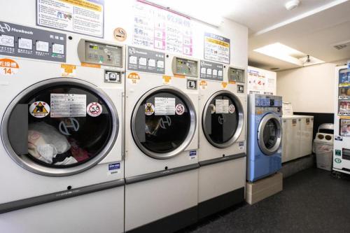 a row of washing machines in a laundrette at Green Hill Hotel Urban in Kobe