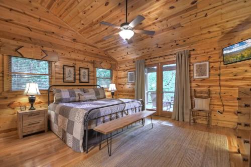 a bedroom with a bed in a log cabin at A Little Bit of Heaven Swim in the creek soak in the hot tub and relax in comfort in Copperhill