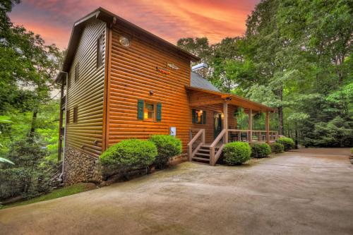 a log cabin with a driveway in front of it at A Little Bit of Heaven Swim in the creek soak in the hot tub and relax in comfort in Copperhill
