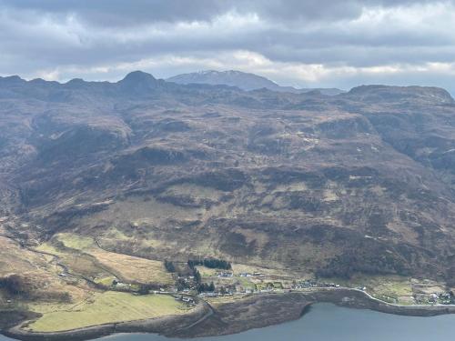 an aerial view of a mountain with a body of water at An Iolaire in Dornie