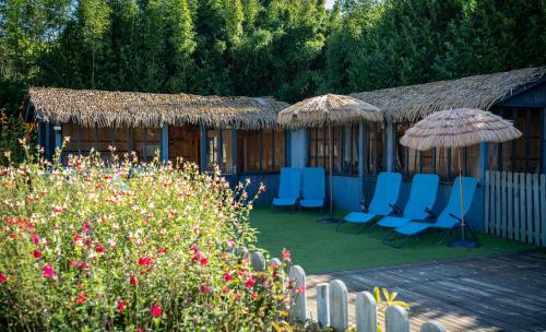 a group of chairs and umbrellas in a garden at Domaine du Turbais in Luynes