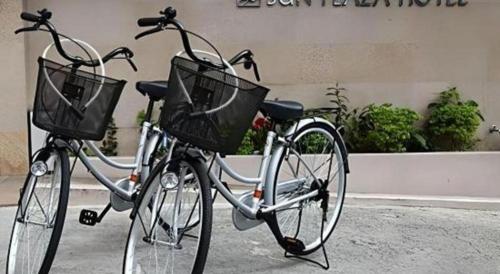 two bikes parked next to each other on a street at Okinawa Sunplaza Hotel in Naha