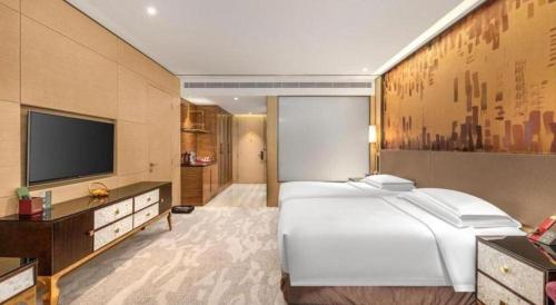Postel nebo postele na pokoji v ubytování Shijiazhuang Ximeijin Continental Hotel
