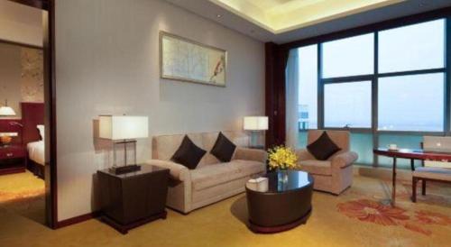 a living room with a couch and a table at Xi'an Airport Hotel in Xi'an