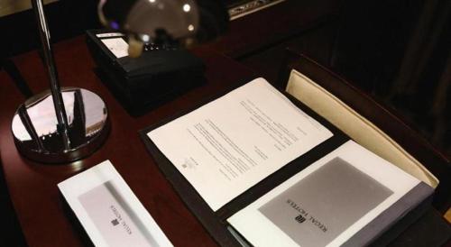 a wooden table with an open book on a table at Xi'an Airport Hotel in Xi'an