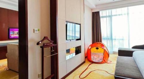 a living room with a childs toy in a room at Xi'an Airport Hotel in Xi'an