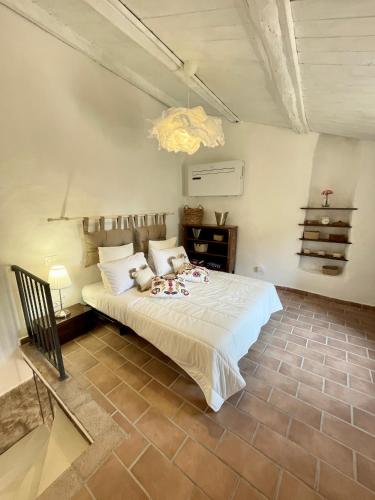 a bedroom with a large white bed in a room at Romantic House in Trevignano Romano