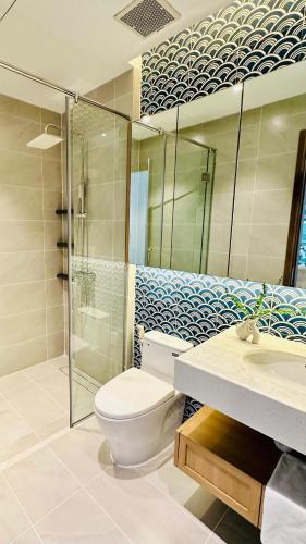 a bathroom with a toilet and a shower and a sink at Вилла на Bai Khem in Phu Quoc