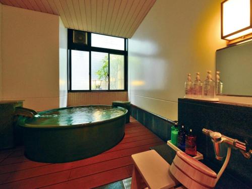 a large bathroom with a large tub in it at Hadano Yugawara Onsen Manyo no Yu in Hadano
