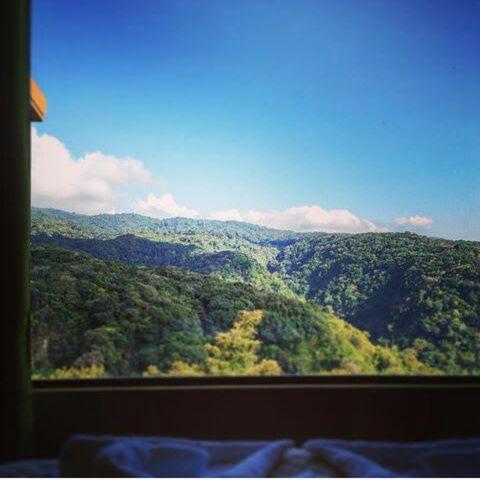 a view of a mountain view from a window at Rainbow Valley Lodge Costa Rica in Monteverde Costa Rica