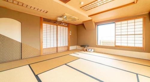 an empty room with a room with windows and a room with a room at Business Hotel Nishiura Yokkaichi in Yokkaichi