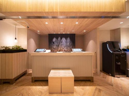 a room with a counter with a stove in it at Super Hotel anashiyakusyomae in Anan