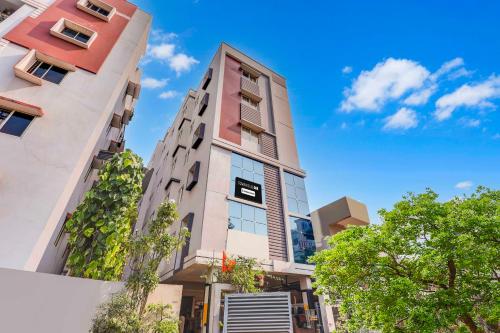 a tall building with a blue sky in the background at Collection O Dwarka Nagar Ramatalkies in Visakhapatnam