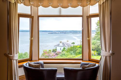a window with chairs and a view of the water at Thornbank House in Stranraer