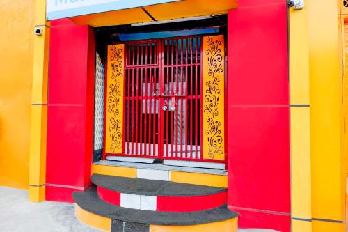 a colorful building with a red and yellow door at Collection O Nehru Nagar in Ghaziabad