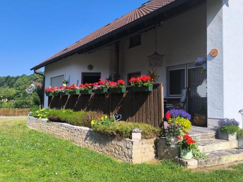 a house with flower boxes on the front of it at Ferienwohnung Altmühlblick in Pappenheim