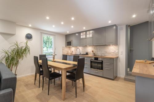 a kitchen and dining room with a table and chairs at Le Moulin paradis entre Genève&Annecy in Viry