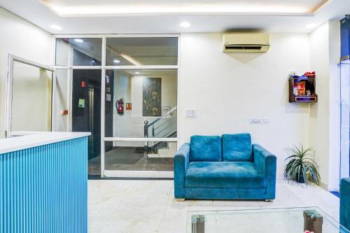 a blue chair sitting in a room with a lobby at Collection O Jagatpura in Jaipur