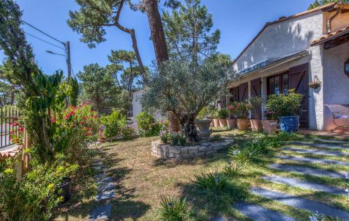 a garden with flowers and plants in front of a building at Charmante Maison Avec Piscine in Saint-Georges-de-Didonne