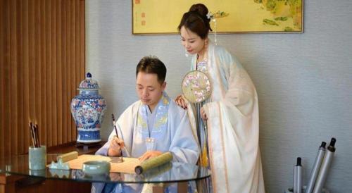 a man and a woman standing next to a table at Deacon House Wuxi in Wuxi