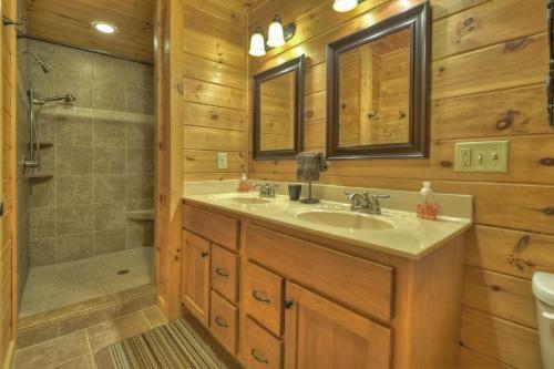 a bathroom with a sink and a shower at Sweet Seclusion Firepit king suite serene outdoor spaces in Mineral Bluff