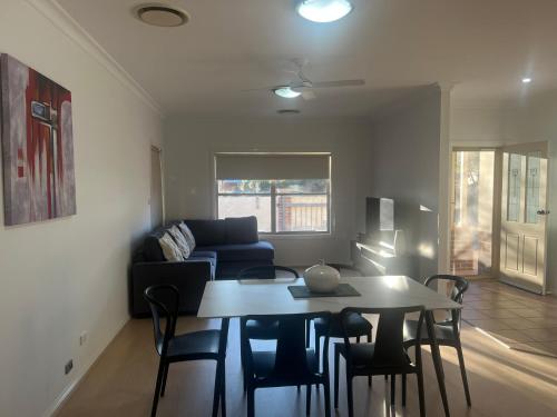 a living room with a table and a couch at Griffith Prestige Apartment in Griffith